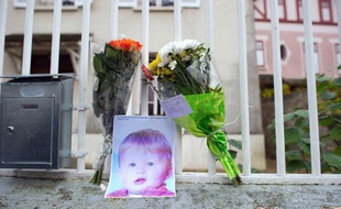 Une photo de Bastien et des fleurs déposées devant le domicile de ses parents, à Germigny-l'Evêque (Seine-et-Marne) le 28 novembre 2011.