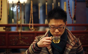 Shen Jun Yi drinks Tregothnan British tea at a tea house in the Hongqiao Antique and Tea Center in downtown Shanghai January 25, 2013. Tregothnan is bucking an historic trend by growing tea in England and exporting almost half of it abroad, including to tea-growing nations like China and India. Owned by a descendant of 19th century British Prime Minister Charles Grey, after whom the Earl Grey tea blend was named, the Tregothnan estate has been selling tea since 2005 and currently produces around 10 tonnes a year of tea and infusions. Picture taken January 25, 2013.