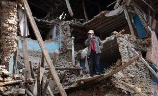 A Nepalese villagers stands in the rubble of damaged homes at Kritipur at the Kathmandu Valley on May 2, 2015. Nepal has ruled out the possibility of finding more survivors buried in the rubble from a massive earthquake that killed more than 6,700 people and devastated vast swathes of one of Asia's poorest countries. AFP PHOTO/MENAHEM KAHANA