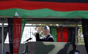 Afghan President Hamid Karzai salutes just before the gun firing which he survived during a celebration in Kabul April 27, 2008. Karzai was hussled away but escaped unhurt after an assassination attempt during an official celebration in the capital, Kabul, on Sunday. REUTERS/Omar Sobhani (AFGHANISTAN)