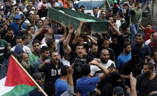Des Palestiniens portent le corps de Ahmad Qali pendant ses funérailles dans le camp de réfugiés de Chouafat dans Jerusalem Est le 10 octobre 2015