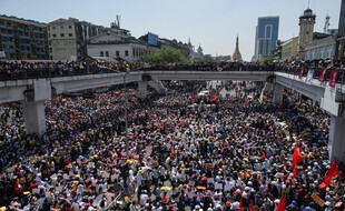 Protesters block a major road during a demonstration against the military coup in Yangon on February 17, 2021. (Photo by Ye Aung THU / AFP)