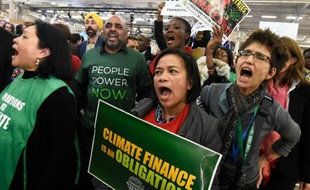 Des manifestants défilent devant le Bourget où se tient la COP21 à Paris, le 9 décembre 2015