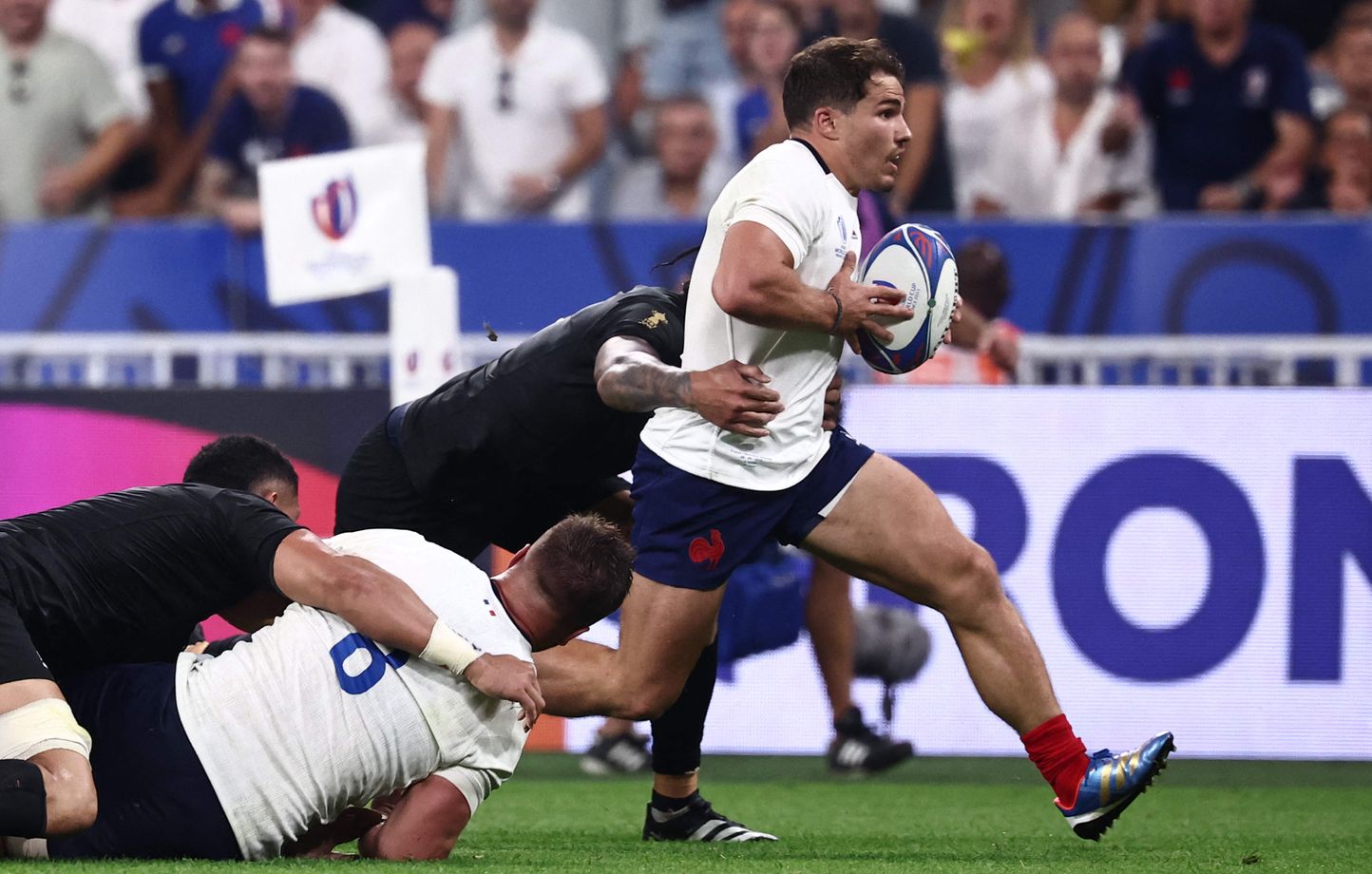 Antoine Dupont en pleine percée face aux All Blacks. 