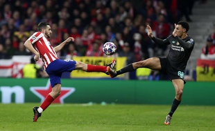 Atletico Madrid's Koke, left, and Liverpool's Trent Alexander-Arnold fight for the ball during a 1st leg, round of 16, of the Champions League soccer match between Atletico Madrid and Liverpool at the Wanda Metropolitano stadium in Madrid, Tuesday, Feb. 18, 2020.
