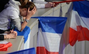 A woman looks emotional as supporters of right-wing incumbent Nicolas Sarkozy are gathered in Paris at " La Mutualite" hall on May 06, 2012.The French turned out for a vote tipped to make Nicolas Sarkozy the latest European leader ousted by economic crisis and Francois Hollande the country's first Socialist president in nearly two decades. AFP PHOTO / MARTIN BUREAU