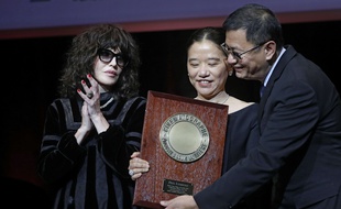 Wong Kar-wai pose, avec son épouse et Isabelle Adjani, lors de la remise du Prix Lumière 2017, vendredi 20 octobre à Lyon.