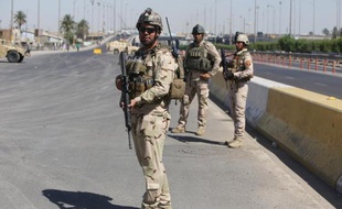 Des soldats irakiens montent la garde devant le principal centre de recrutement de volontaires à Bagdad pour lutter contre les jihadistes le 24 juin 2014