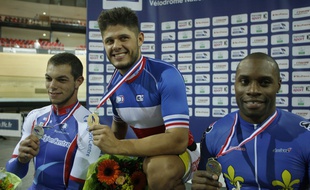 (From L) French Kevin Sireau (silver), Quentin Lafargue (gold) and Gregory Bauge (bronze) pose during the podium ceremony of the sprint contest of the French track cycling championship in Montigny-le-Bretonneux, on October 3, 2014. AFP PHOTO / MATTHIEU ALEXANDRE