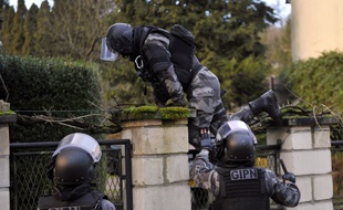 TOPSHOTS
Members of the French police special force GIPN carry out searches in Corcy, northern France, on January 8, 2015 as part of an investigation into a deadly attack the day before by armed gunmen on the Paris offices of French satirical weekly Charlie Hebdo. A huge manhunt for two brothers suspected of massacring 12 people in an Islamist attack at a satirical French weekly zeroed in on a northern town on January 8 after the discovery of one of the getaway cars. As thousands of police tightened their net, the country marked a rare national day of mourning for January 7's bloodbath at Charlie Hebdo magazine in Paris, the worst terrorist attack in France for half a century. AFP PHOTO / FRANCOIS LO PRESTI