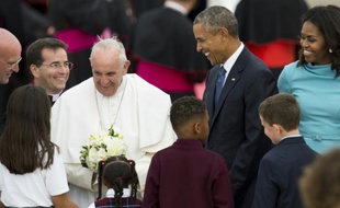 Le pape François, entouré de Barack et Michelle Obama, reçoit des fleurs à son arrivé à Andrews Air Force Base dans le Maryland aux Etats-Unis le 22 septembre 2015