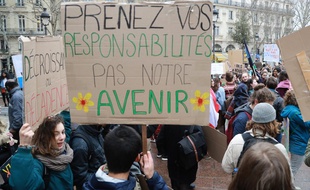 Des étudiants brandissent des pancartes appelant l'Etat français à renforcer son action climatique, le 1er mars à Paris.