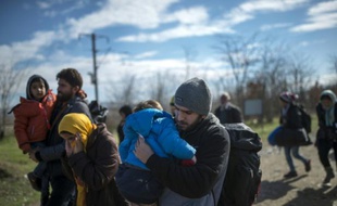 Des migrants franchissent la frontière entre la Grèce et la Madécoine le 14 février 2016 à Gevgelija