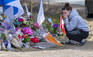 Une jeune femme rend hommage aux 22 victimes de la tuerie de Portapique au Canada. (illustration)