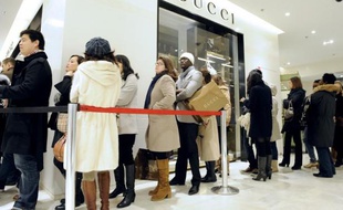Des clients font la queue devant une boutique Gucci à Paris, pendant les soldes