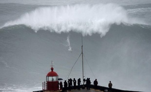 Le surfeur brésilien Carlos Burle surfe une énorme vague, sur le spot de Praia di Norte, à Nazaré au Portugal, le 28 octobre 2013