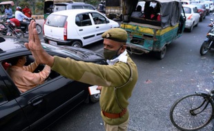 Un policier portant un masque dans la banlieue de New Dehli le 25 février 2015