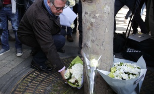 Paris, le 21 avril 2017. - Denis Jacob, secrétaire général du syndicat d'Alternative Police CFDT, dépose des fleurs à l'endroit où un policier a été tué par un assaillant sur les Champs-Elysées, la veille.