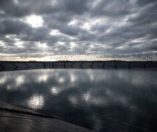 Birds fly over the first mega-retention pond project (structures which pumps water from groundwater and used to maintain intensive monoculture) near the pond in Mauze-sur-le-Mignon, western France, on February 23, 2022. - Opponents to the mega-retention ponds say the structures weaken local biodiversity, monopolize water for the benefit of a few and promote agriculture that is harmful to human health and that of nature. (Photo by PHILIPPE LOPEZ / AFP)