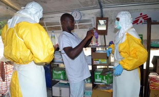 Des membres de Médecins sans Frontières sécurisent un département de l'hôpital de Donka à Conakry, le 23 juillet 2014 pour éviter la propagation du virus Ebola