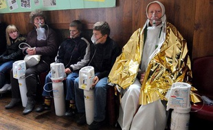 Des personnes, dont le curé de la paroisse respirent de l'oxygène, le 8 novembre 2009 dans la salle des fêtes d'Angres apres avoir été intoxiquées au monoxyde de carbone lors d'une messe à l'église Saint Cyr.