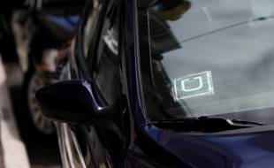 Un sticker avec le logo de Uber est collé sur la vitre d'une voiture, le 12 juin 2014 à San Francisco