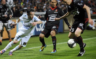 L'attaquant de l'OM, Mathieu Valbuena (en blanc) tente de s'échapper sur l'aile face à deux joueurs rennais, le 5 mai 2010 au stade Vélodrome.