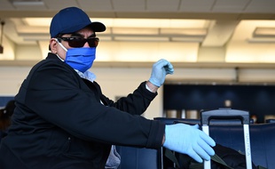 Un voyageur masqué dans un aéroport (illustration).