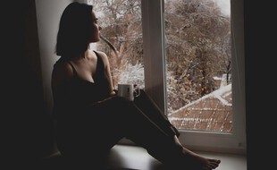 Illustration d'une jeune femme regardant à la fenêtre.