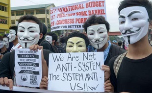 Des manifestants du groupe Anonymous portant le masque de Guy Fawkes devant le Parlement philippin, à Manille le 5 novembre 2013.