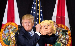 Donald Trump takes a break from speaking to compare his face to a mask during a rally at the Sarasota Fairgrounds in Sarasota, Fla., on Monday, Nov. 7, 2016. Trump spotted the mask in the crowd, and had it passed up to him. (Loren Elliott/The Tampa Bay Times via AP) /FLPET103/717021754324/TAMPA OUT; CITRUS COUNTY OUT; PORT CHARLOTTE OUT; BROOKSVILLE HERNANDO TODAY OUT; MANDATORY CREDIT-/1611072052