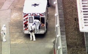 An ambulance arrives with Ebola victim Dr. Kent Brantly, right, to Emory University Hospital, Saturday, Aug. 2, 2014, in Atlanta. Brantly, infected with the Ebola virus in Africa arrived in Atlanta for treatment Saturday, landing in a specially equipped plane at a military base, then being whisked away to one of the most sophisticated hospital isolation units in the country, officials say. (AP Photo/WSB-TV Atlanta) METRO ATLANTA TV OUT/GAMS104/822407735394/
METRO ATLANTA TV OUT
/1408022056