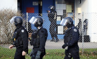 Des membres du GIPN accompagnent des enfants à l'extérieur de l'école de maternelle où une prise d'otages a eu lieu le 13 décembre 2010 à Besançon (Doubs).