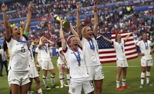 United States' Megan Rapinoe, center, holds the trophy as she celebrates with teammates after they defeated the Netherlands 2-0 in the Women's World Cup final soccer match at the Stade de Lyon in Decines, outside Lyon, France, Sunday, July 7, 2019