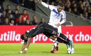 Le défenseur du TFC François Moubandje à la lutte avec l'attaquant lyonnais Alexandre Lacazette, vendredi au stade Gerland.