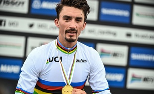 France's Julian Alaphilippe poses with his medal on the podium after winning the Men's Elite Road Race, a 258.2-kilometer route around Imola, Emilia-Romagna, Italy, on September 27, 2020 as part of the UCI 2020 Road World Championships.