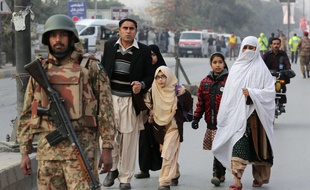 Pakistani parents escort their children outside a school attacked by the Taliban in Peshawar, Pakistan, Tuesday, Dec. 16, 2014. Taliban gunmen stormed a military-run school in the northwestern Pakistani city of Peshawar on Tuesday, killing and wounding scores, officials said, in the highest-profile militant attack to hit the troubled region in months. (AP Photo/B.K. Bangash)/BKB102/761309588222/1412161334