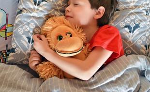 Illustration d'un enfant dans son lit.