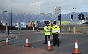 Des policiers surveillent les abords de la Manchester Arena, au lendemain de l'attentat terroriste qui a fait au moins 22 morts.