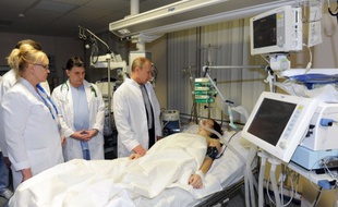 Vladimir Poutine rend visite à la skieuse russe Maria Komissarova, le 16 février 2014, à Sotchi.