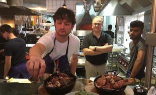 Julien Chevallier apporte une dernière touche à ses pièces de viande cuites au barbecue chez Justine, à Paris