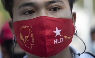 Un masque aux couleurs du parti d'Aung San Suu Kyi, et avec son visage.
