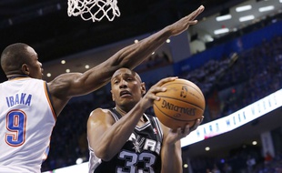 San Antonio Spurs forward Boris Diaw (33) drives under the basket past Oklahoma City Thunder forward Serge Ibaka (9) in the third quarter of Game 4 of the Western Conference finals NBA basketball playoff series in Oklahoma City, Tuesday, May 27, 2014. Oklahoma City won 105-92. (AP Photo/Sue Ogrocki)/OKSO122/602125469039/1405280628