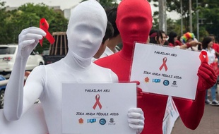 Deux militants en campagne de prévention contre le sida le 1er décembre 2014, à Surabaya, en Indonésie.