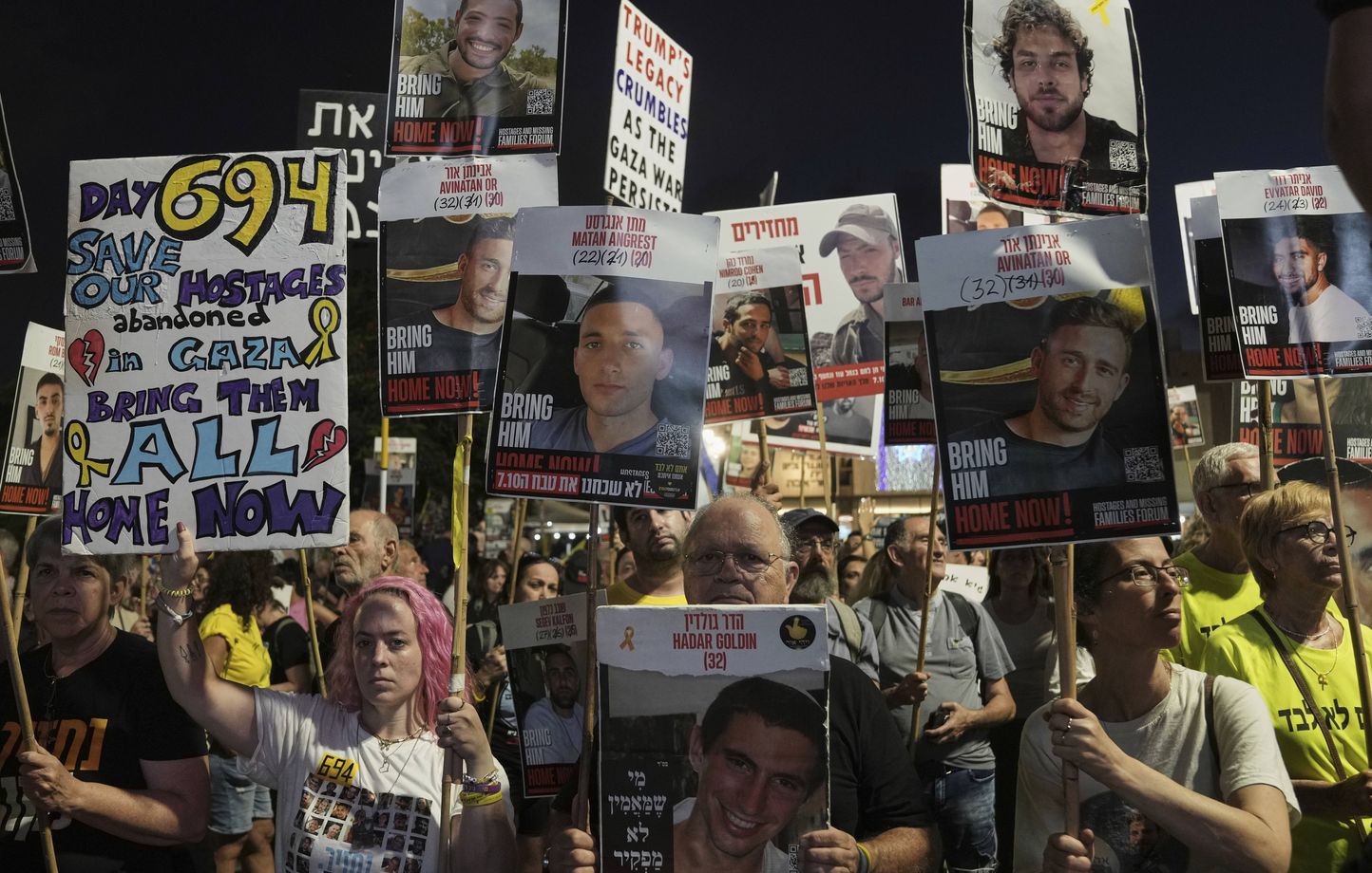 People attend a rally demanding the immediate release of all hostages held by Hamas and calling for an end of the war in the Gaza Strip, at a plaza known as the hostages square in Tel Aviv, Israel, Saturday, Aug. 30, 2025. (AP Photo/Mahmoud Illean)/XLC105/25242623531802//2508301925