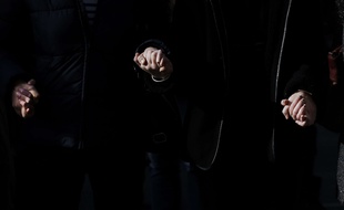 People hold hands as they observe a minute of silence in Lyon, central, Monday, Nov. 16, 2015, three days after the Paris attacks. A minute of silence was observed throughout the country in memory of the victims of the country's deadliest violence since World War II. (AP Photo/Laurent Cipriani)/CIP104/151523097870/1511161407