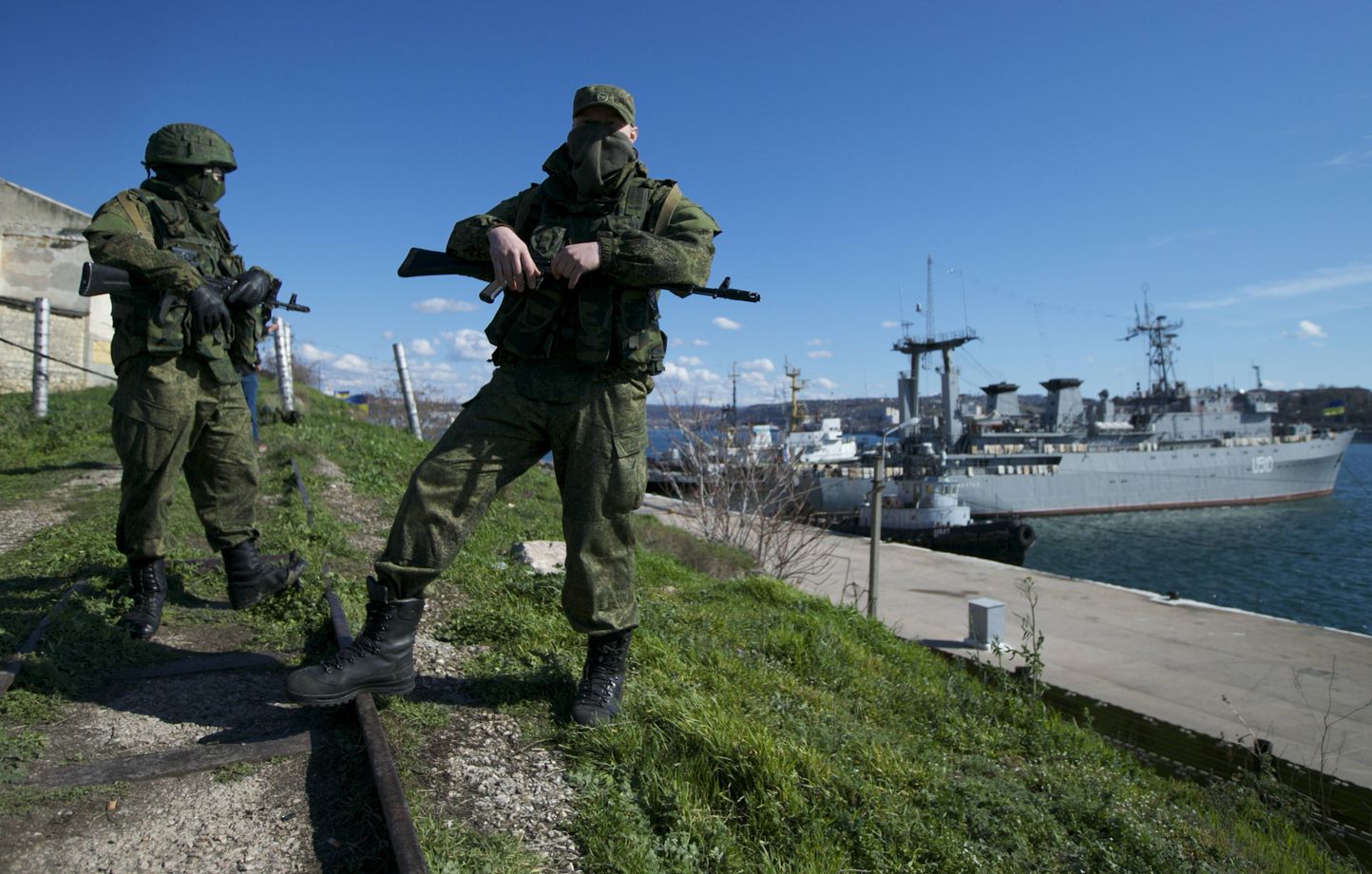 Des soldats russes gardent une jetée où sont amarrés deux navires de guerre ukrainiens, à Sébastopol, en Ukraine, le mercredi 5 mars 2014. 