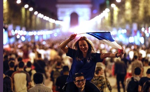 People celebrate on the Champs Elysees avenue, with the Arc de Triomphe in background, to celebrate after the semifinal match between France and Belgium at the 2018 soccer World Cup, Tuesday, July 10, 2018 in Paris. France advanced to the World Cup final for the first time since 2006 with a 1-0 win over Belgium on Tuesday.