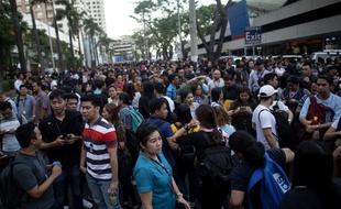 Des travailleurs sortis dans les rues de Manille, après le tremblement de terre qui a secoué les Philippines, le 22 avril 2019.
