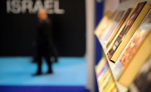 A guest walks past the Israeli stand at the annual Paris book fair which is inaugurated by Israeli President Shimon Peres, on March 13, 2008. Israel is the guest of honour of the Paris book fair. REUTERS/Martin Bureau/Pool (FRANCE)